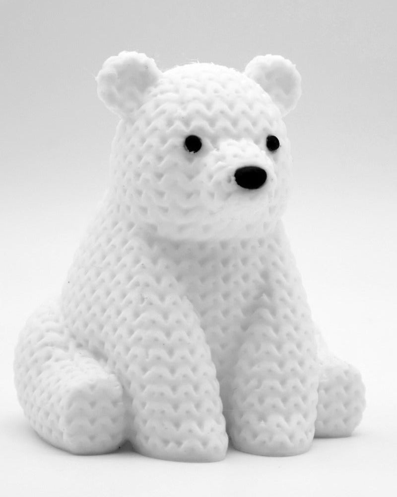 Close-up of a small knitted polar bear figurine with textured crochet-look surface, white, 8 cm tall