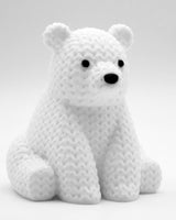 Close-up of a small knitted polar bear figurine with textured crochet-look surface, white, 8 cm tall