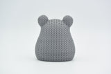 Texture detail of the knitted hamster surface showing the tight crochet-like stitch pattern across its back