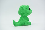 Close-up of a knitted crocodile decoration with textured crochet-look surface and small round eyes, 80mm long