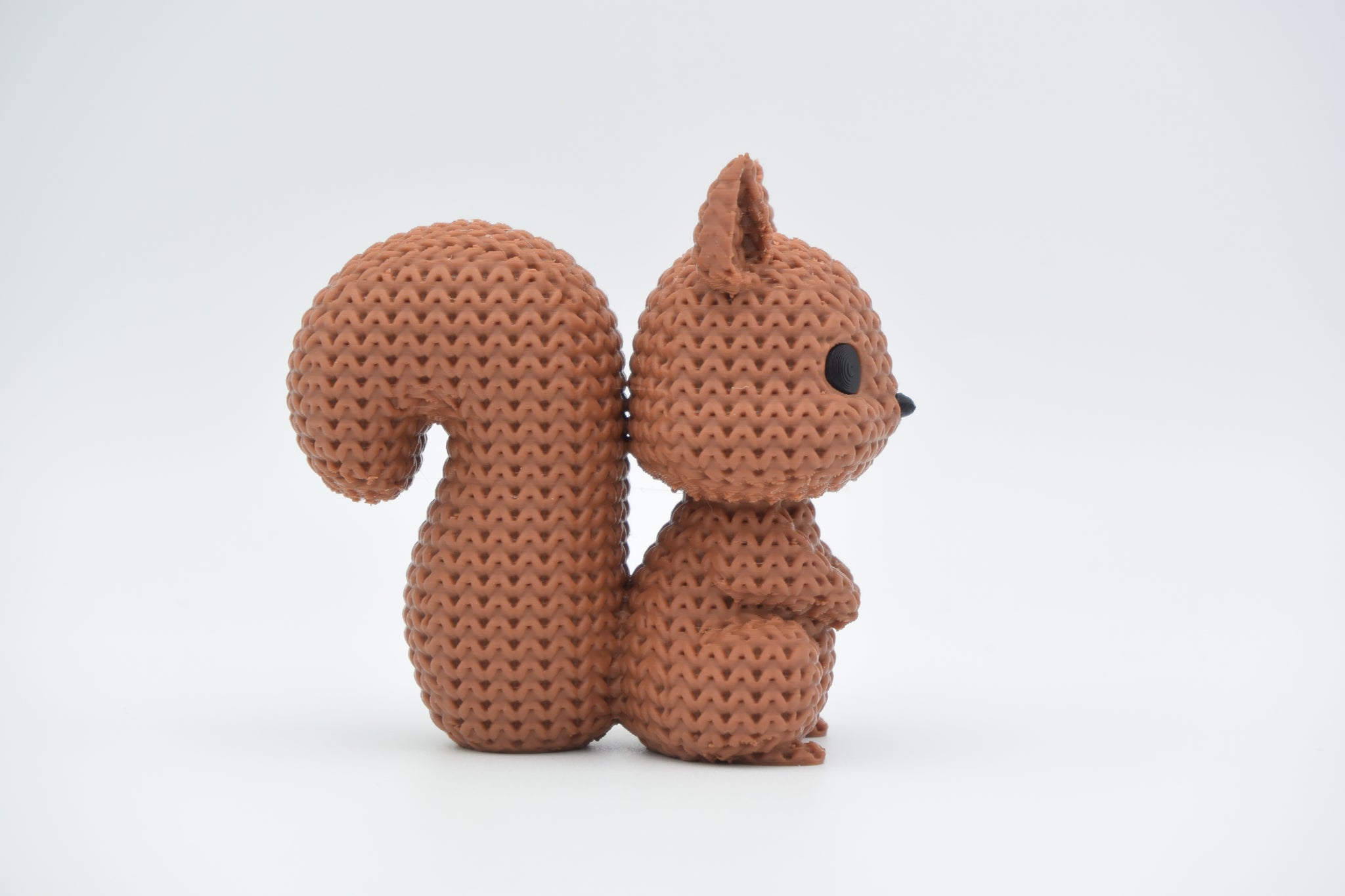 Detail shot of the looped knitted texture on the surface of a decorative squirrel figurine