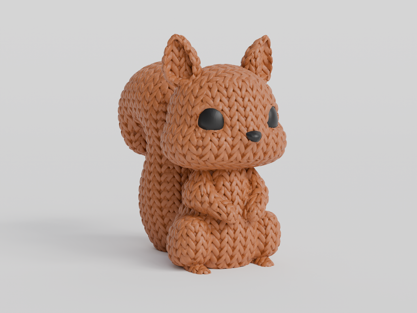 Close-up of a knitted squirrel figurine with a soft crochet-look texture and small glass eyes, 49 DKK