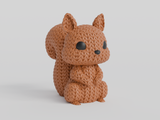 Close-up of a knitted squirrel figurine with a soft crochet-look texture and small glass eyes, 49 DKK