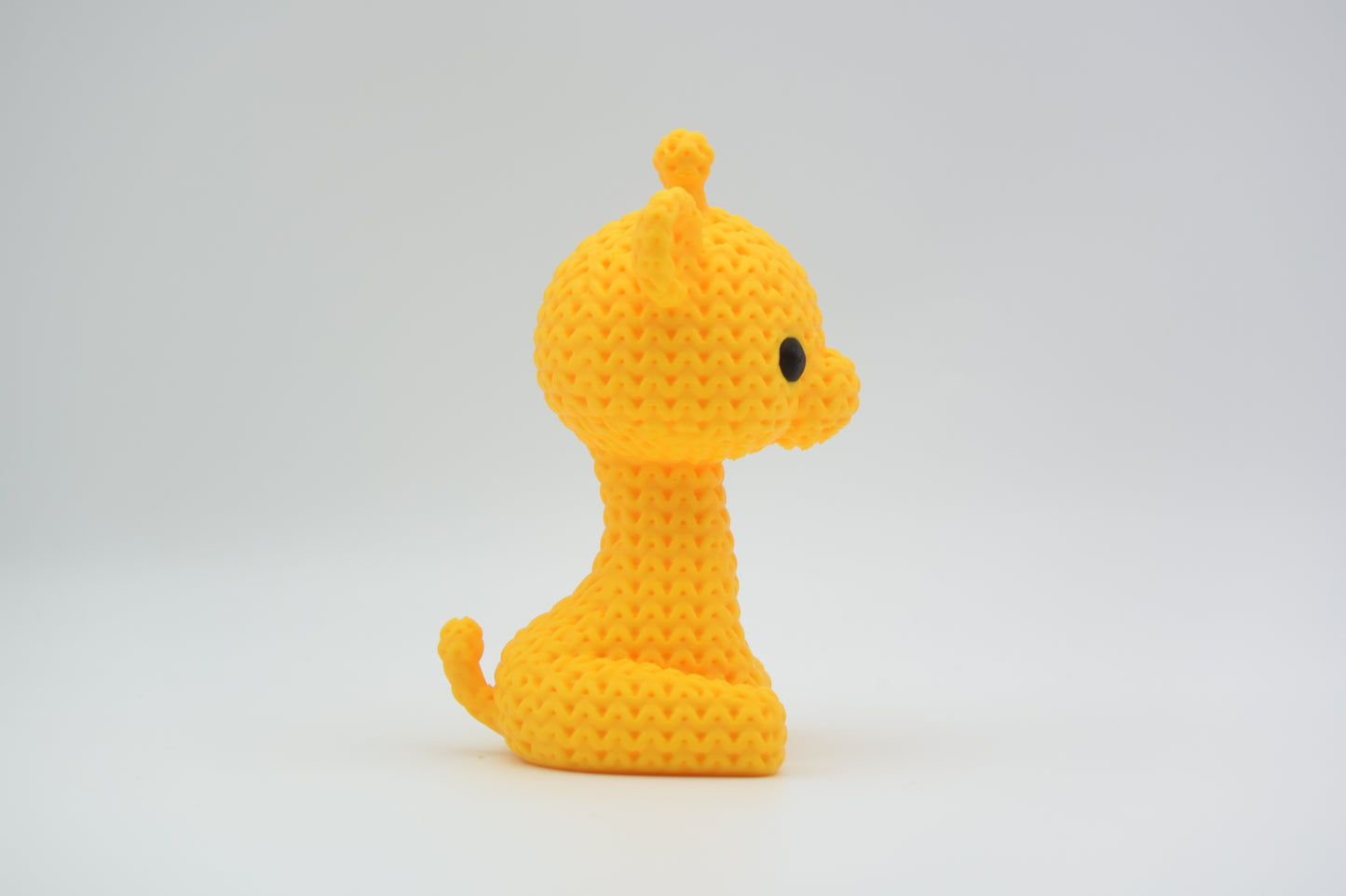 Detail of the open weave crochet-look texture on the surface of a small decorative giraffe figurine