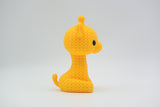 Detail of the open weave crochet-look texture on the surface of a small decorative giraffe figurine