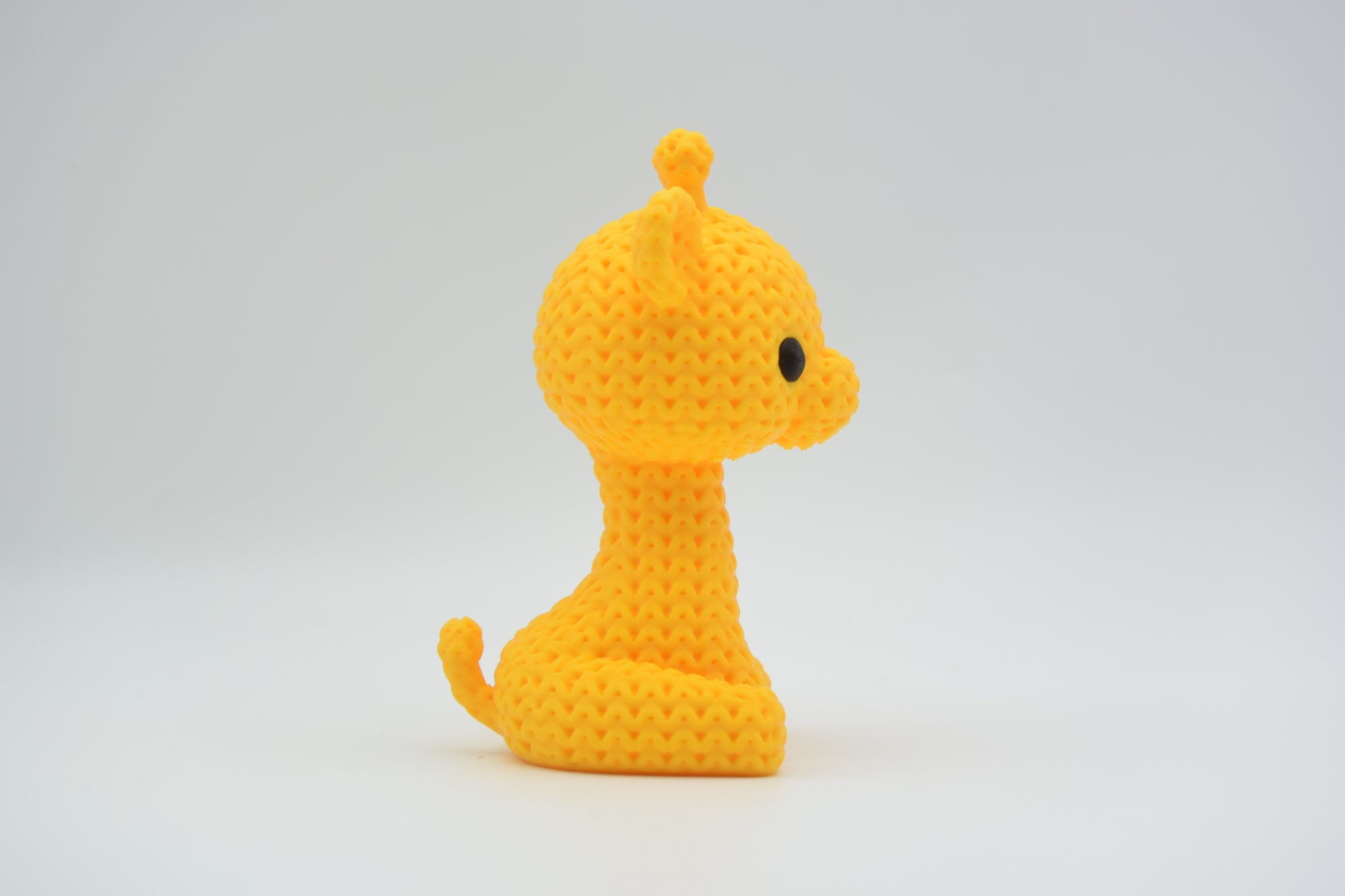 Detail of the open weave crochet-look texture on the surface of a small decorative giraffe figurine