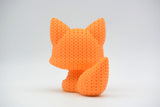 Texture detail of a knitted fox figurine showing the soft, looped crochet-like surface pattern