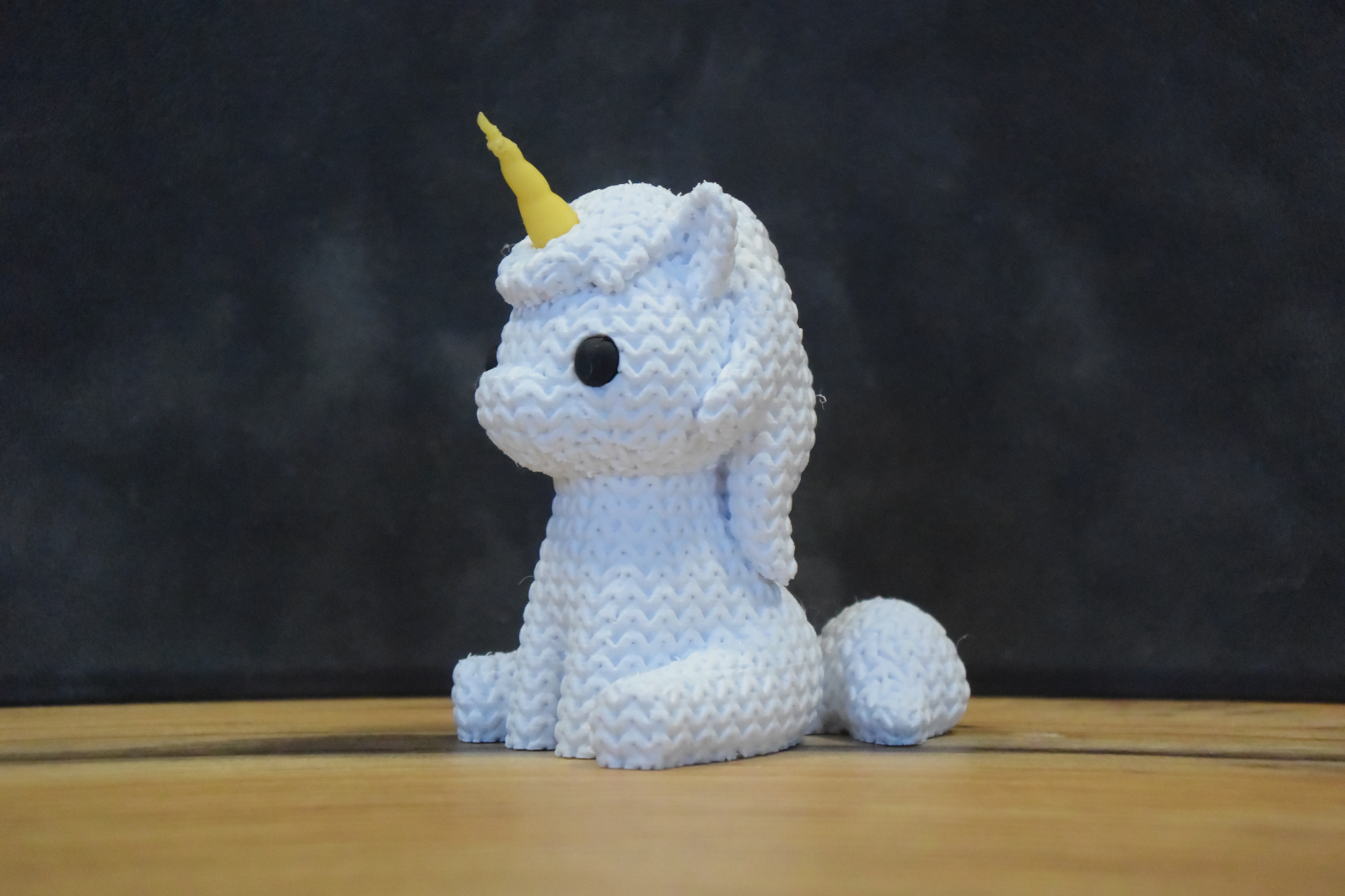 Texture detail of knitted unicorn surface showing soft woven pattern and hand-stitched appearance