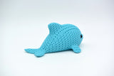 Detail shot of the crochet-look texture on the body of a decorative dolphin figure in grey-blue tones