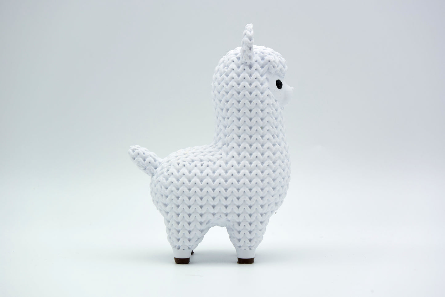 Texture detail of the knitted llama surface showing the raised yarn-like crochet pattern