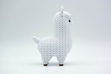 Texture detail of the knitted llama surface showing the raised yarn-like crochet pattern