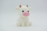 Texture detail of the knitted cow figure showing the close woven surface pattern