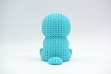 Close-up of a knitted platypus figurine with a soft crochet-look texture, seen from the front