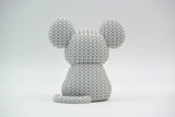 Detail shot of the yarn-like texture on a knitted mouse figure, showing the woven surface pattern up close