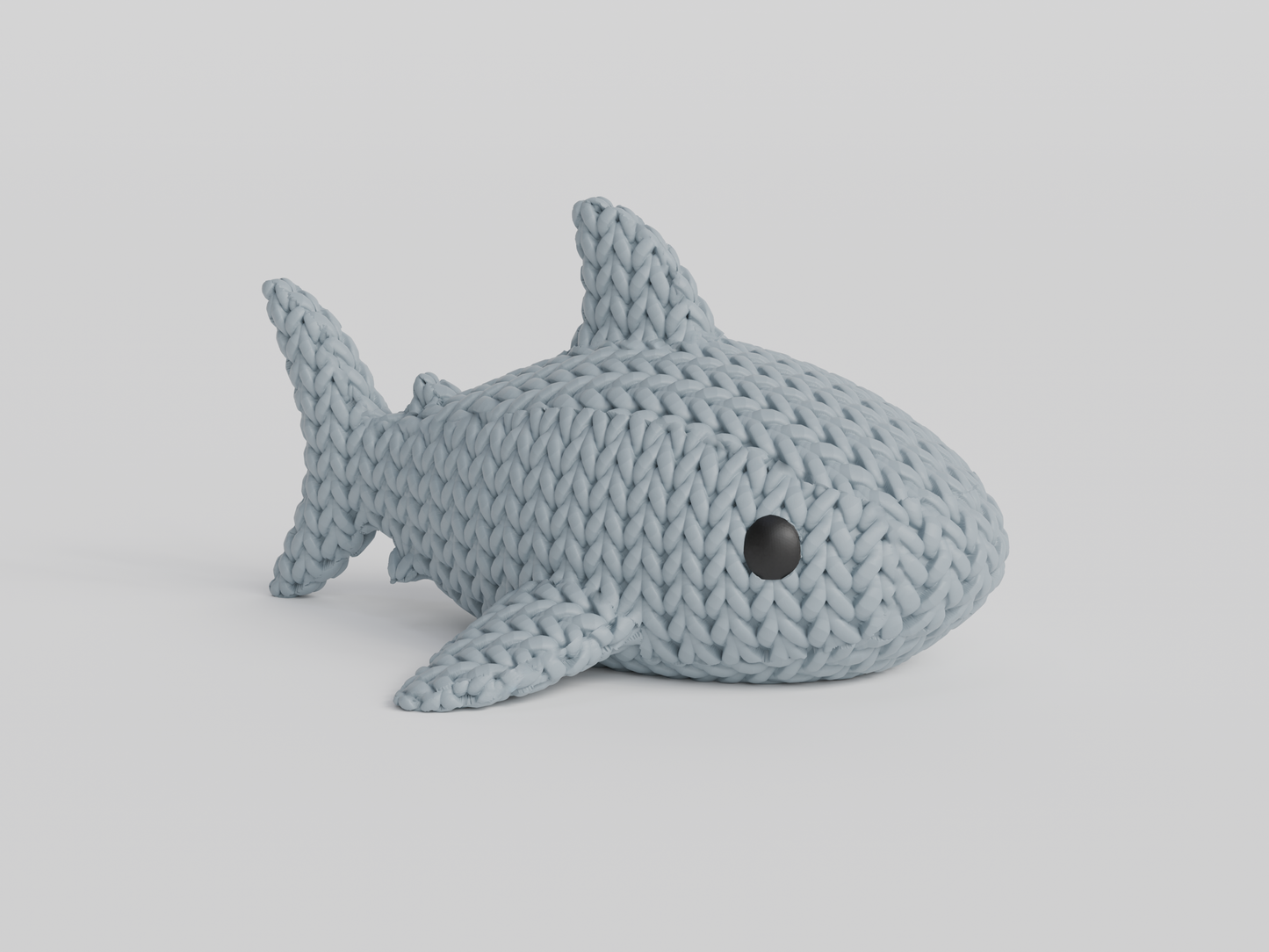 Texture detail of the knitted shark surface showing the looping crochet-style pattern across the body