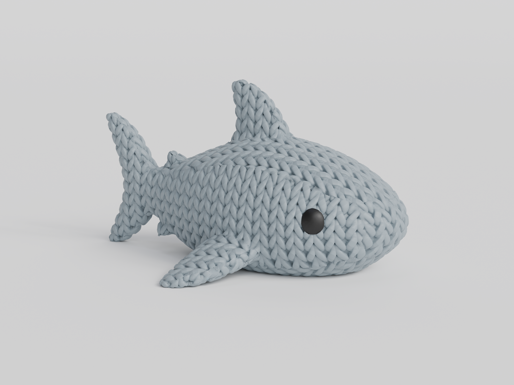 Texture detail of the knitted shark surface showing the looping crochet-style pattern across the body