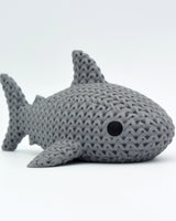 Close-up of a knitted shark figure with a soft crochet-look texture in light grey tones, 80mm long