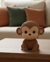 Close-up of a knitted monkey figurine with a detailed crochet-look texture, shown on a light surface
