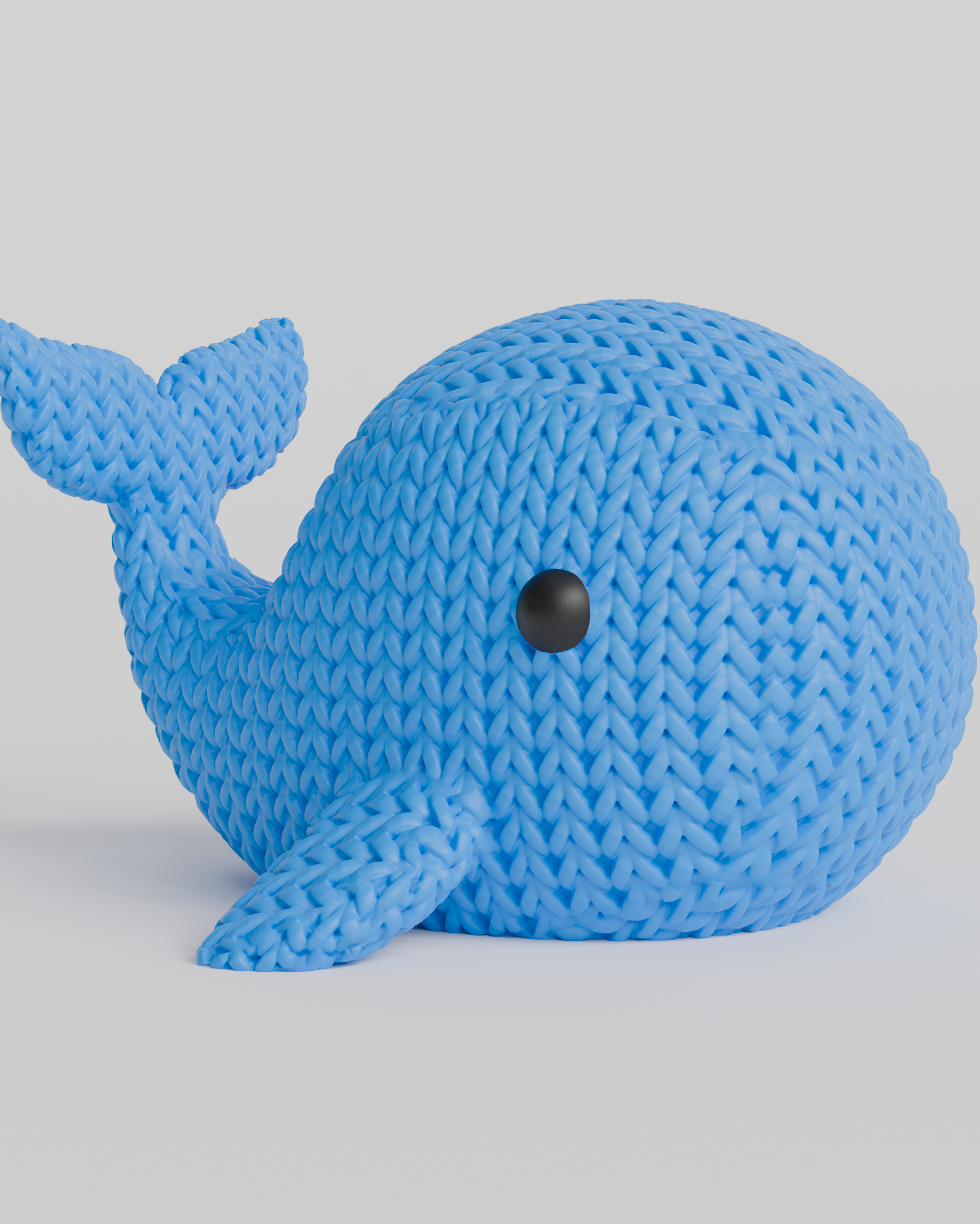 Texture detail of the knitted whale showing the looping stitch pattern across its rounded surface