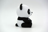 Detail shot of the knitted panda surface texture showing the soft, woven stitch pattern in black and white