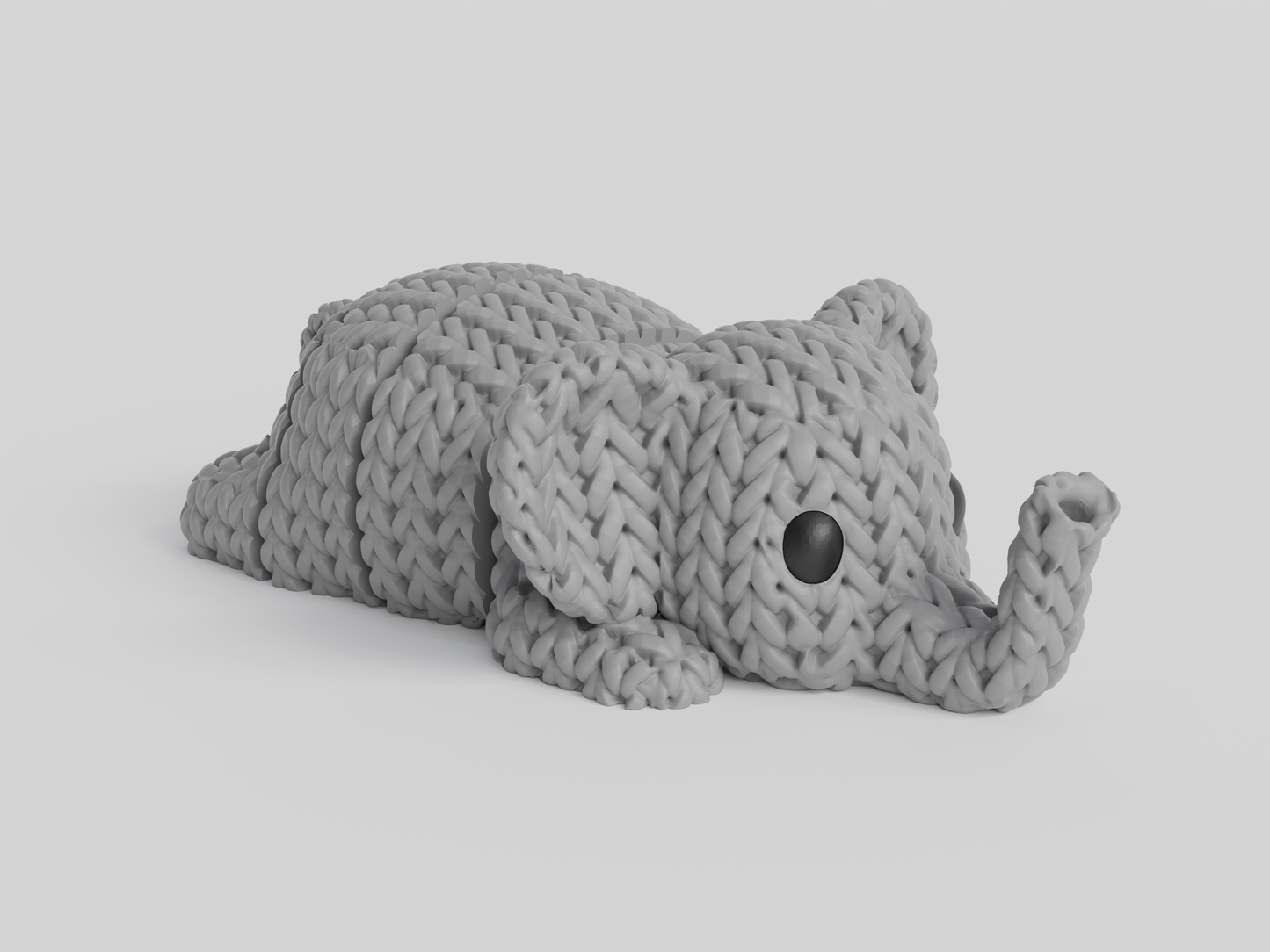 Close-up of a knitted elephant keychain with textured crochet-like surface and articulated body segments
