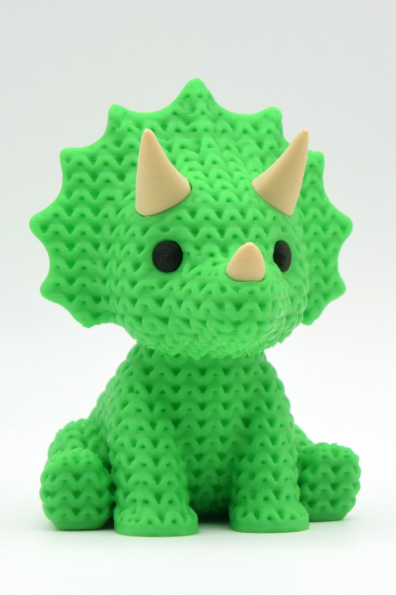 Close-up of a knitted triceratops figurine with textured crochet surface and three horns, 49 DKK