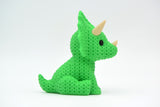 Texture detail of the crochet-look surface on a triceratops figurine showing the woven pattern