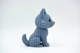 Texture detail of knitted wolf figurine showing soft looped pattern across the back and ears