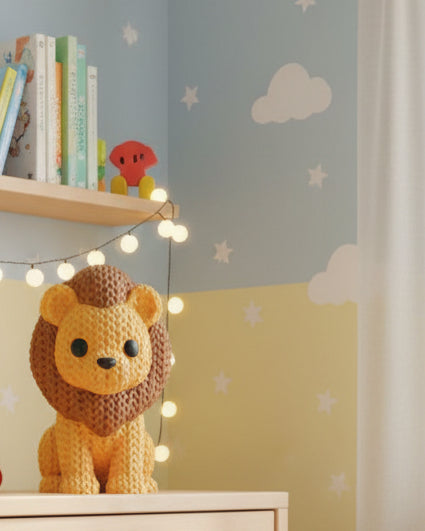 Close-up of a knitted lion figurine with a soft crochet-look texture, shown against a light background