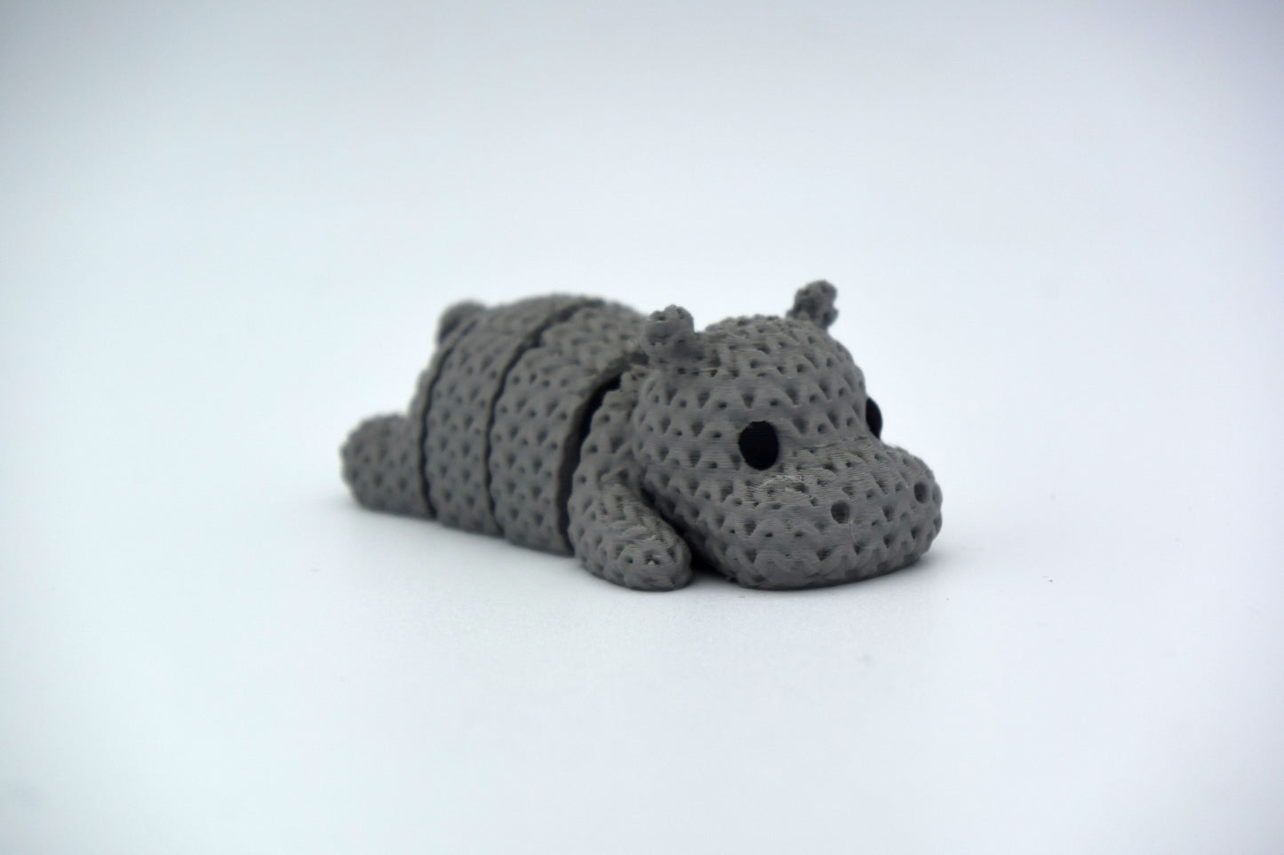 Detail shot of the knitted hippo's segmented body showing the soft woven texture and flexible joints