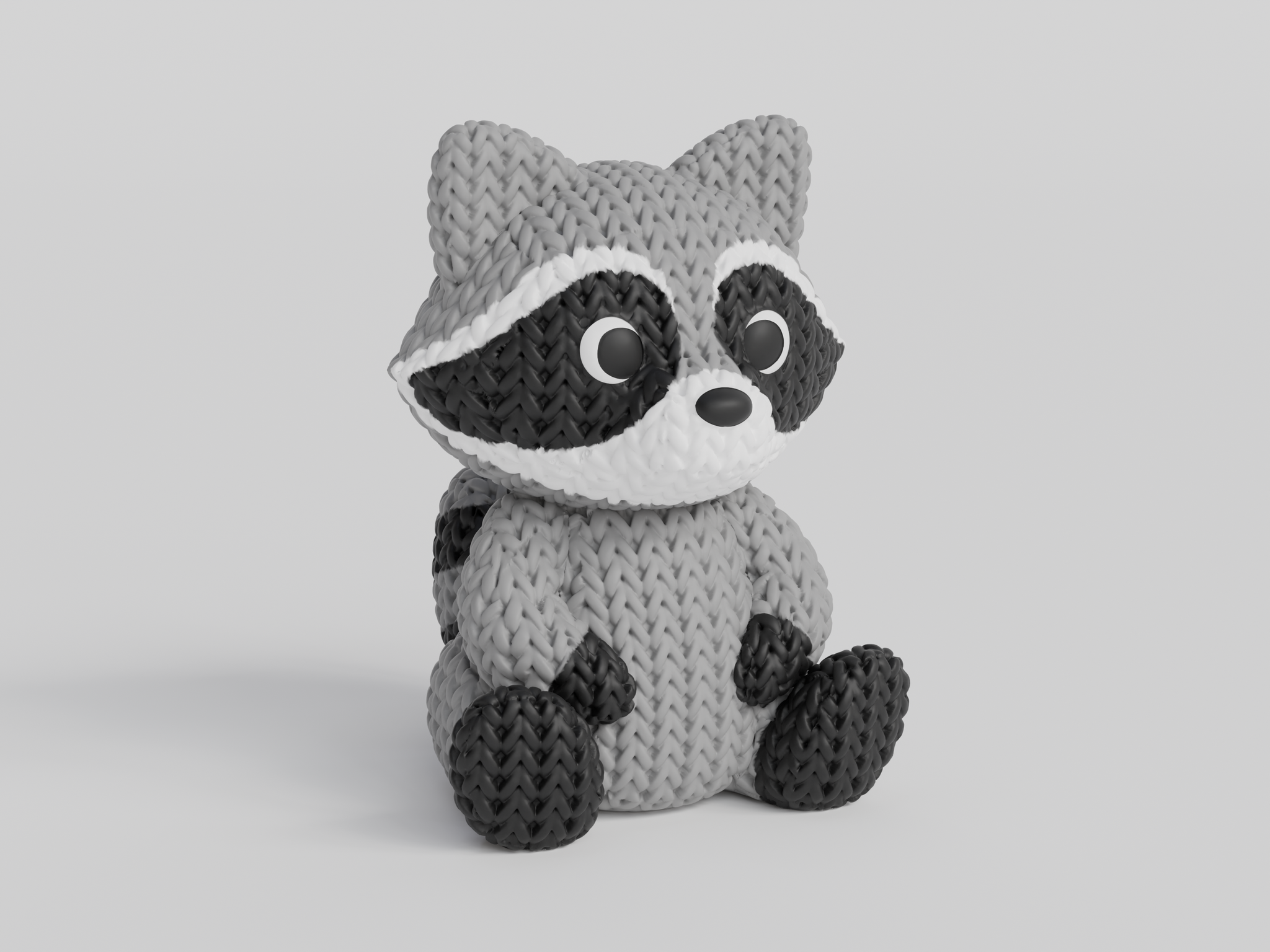 Close-up of a knitted raccoon figurine with a detailed crochet-look texture, shown against a white background