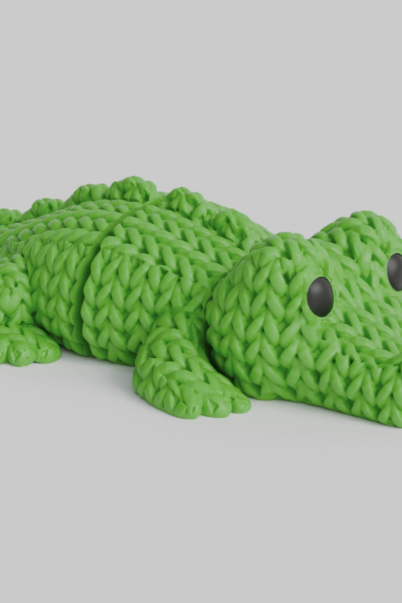 Close-up of a knitted crocodile with textured crochet-look scales and flexible segmented body, 49 DKK