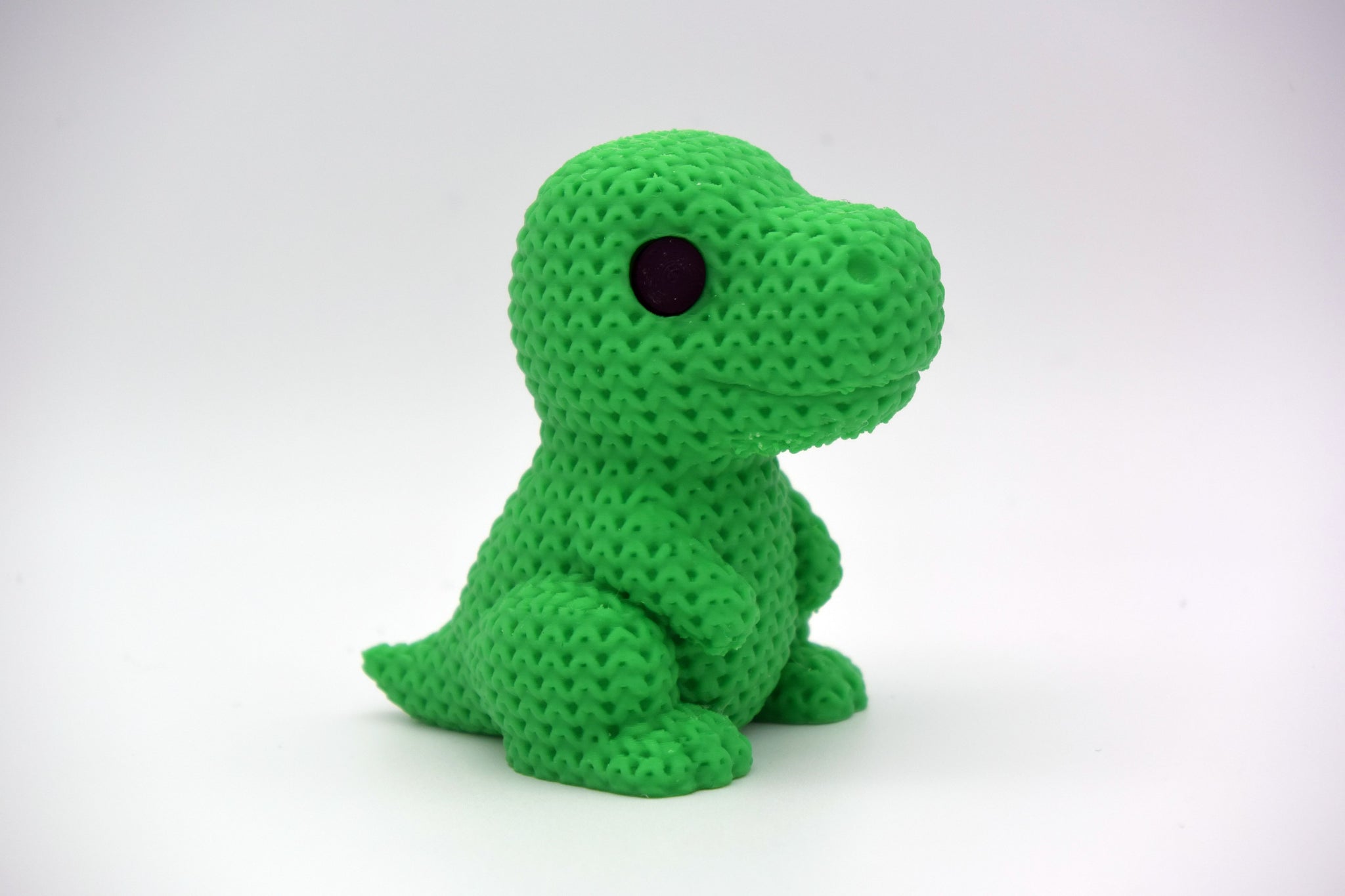 Detailed view of the crochet-style woven texture on the surface of a T-Rex dinosaur figurine