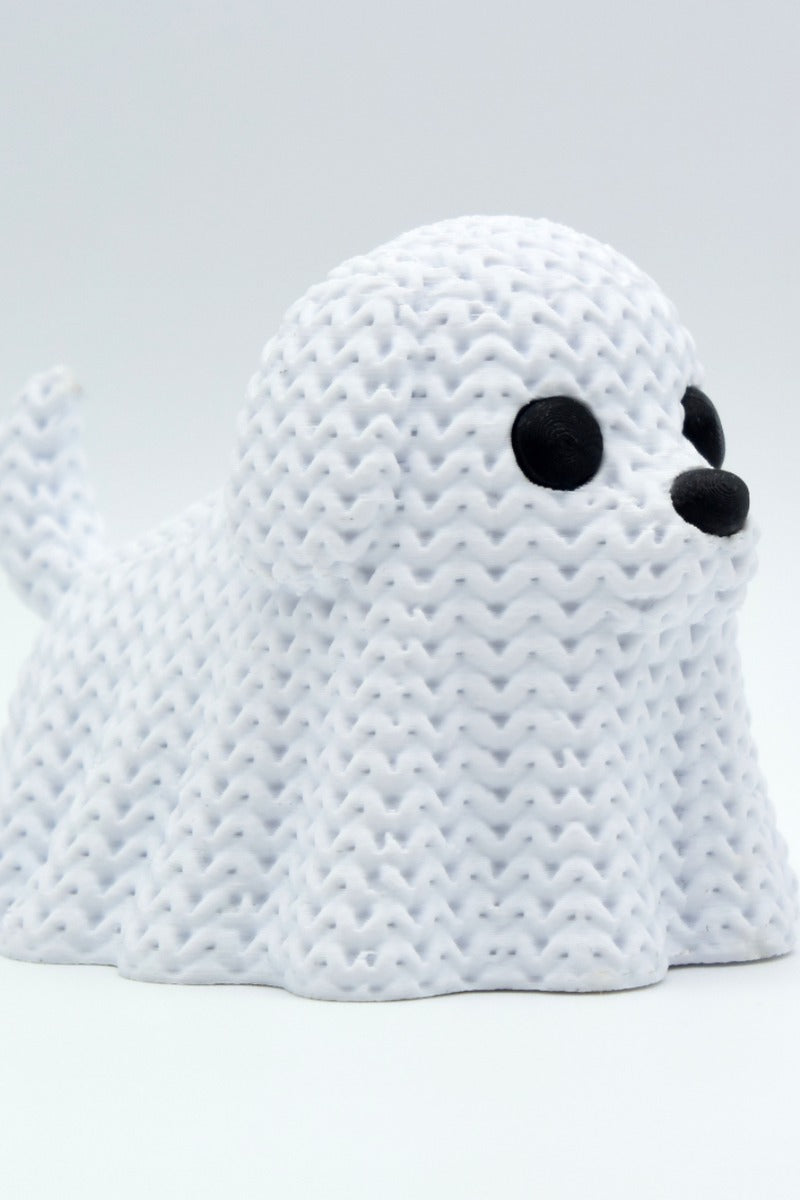 Close-up of a knitted dog ghost decoration with soft crochet-like texture, white with dark eyes, 49 DKK
