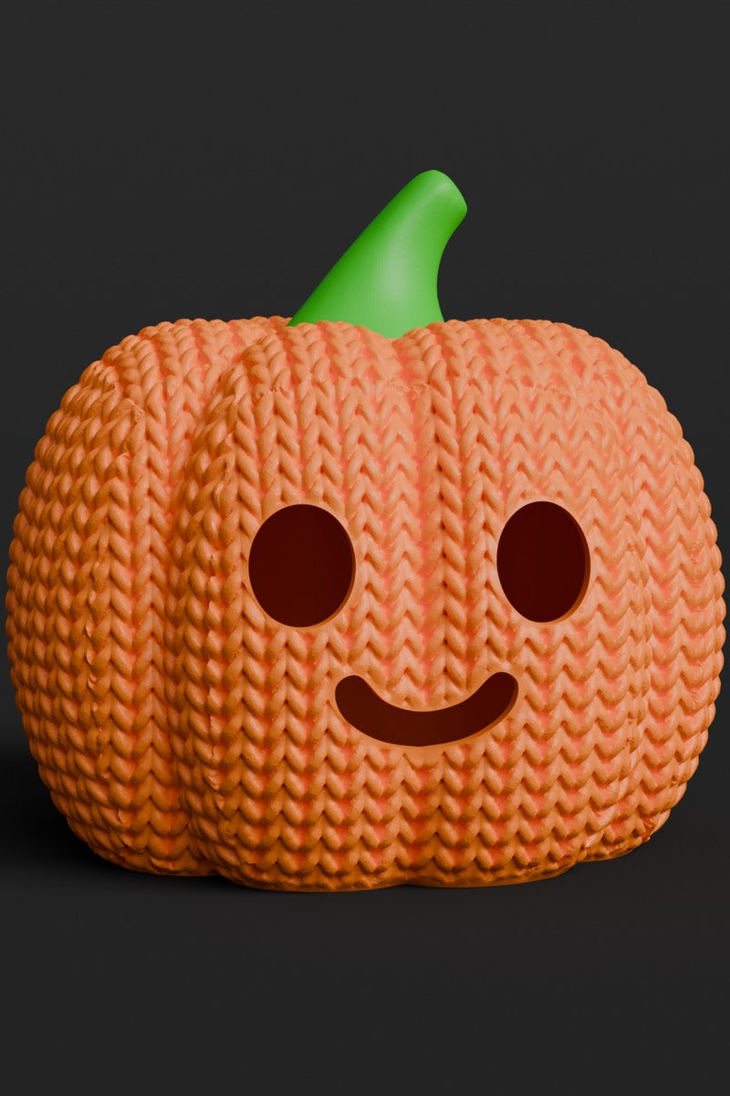 Close-up of a knitted halloween pumpkin with jack-o-lantern face, soft textured orange surface, 49 DKK