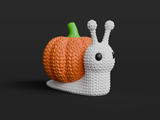 Close-up of a knitted pumpkin snail decoration with soft crochet texture and orange ribbed shell, on white background