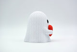Small knitted ghost decoration with heart styled on a wooden shelf among autumn home decor