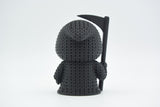 Detail shot of the looping yarn texture on a knitted grim reaper figure, showing the woven surface pattern
