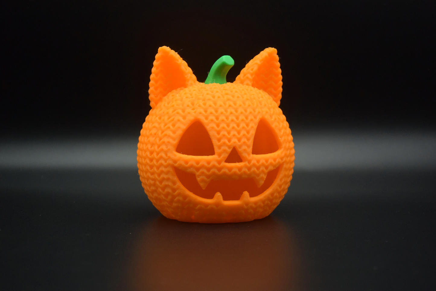 Detail shot of the knitted weave pattern on a crochet cat pumpkin Halloween decoration