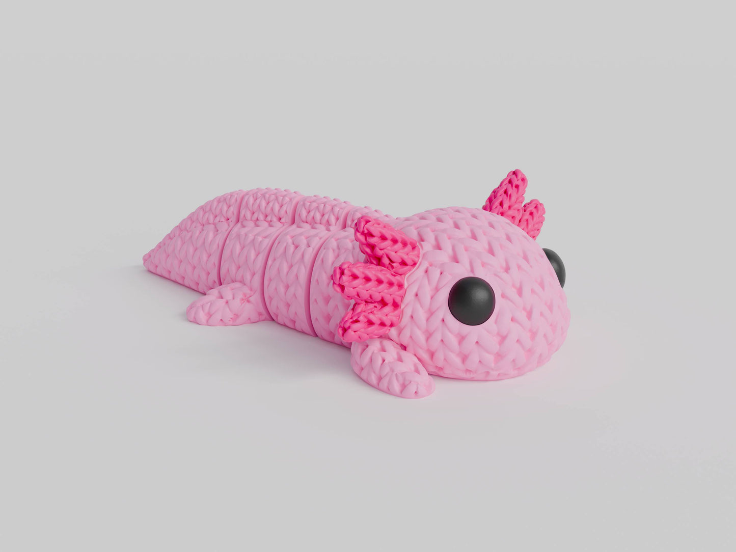 Close-up of a knitted axolotl figure with textured crochet-like surface and soft pink colouring, 49 DKK