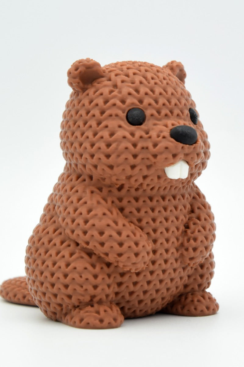 Knitted beaver decoration with crochet-look texture, solid figurine in warm brown tones, close-up view