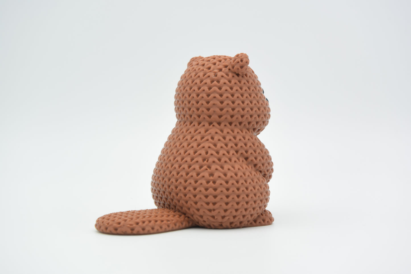 Close-up of the ridge texture on a knitted beaver figurine showing soft crochet-look surface detail