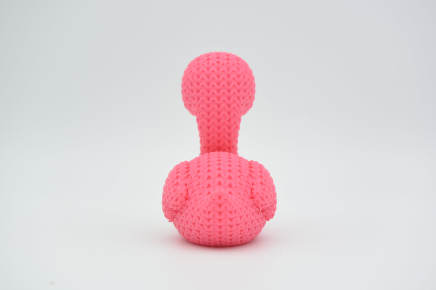 Detail shot of the looping crochet-look texture on the surface of a pink flamingo figurine