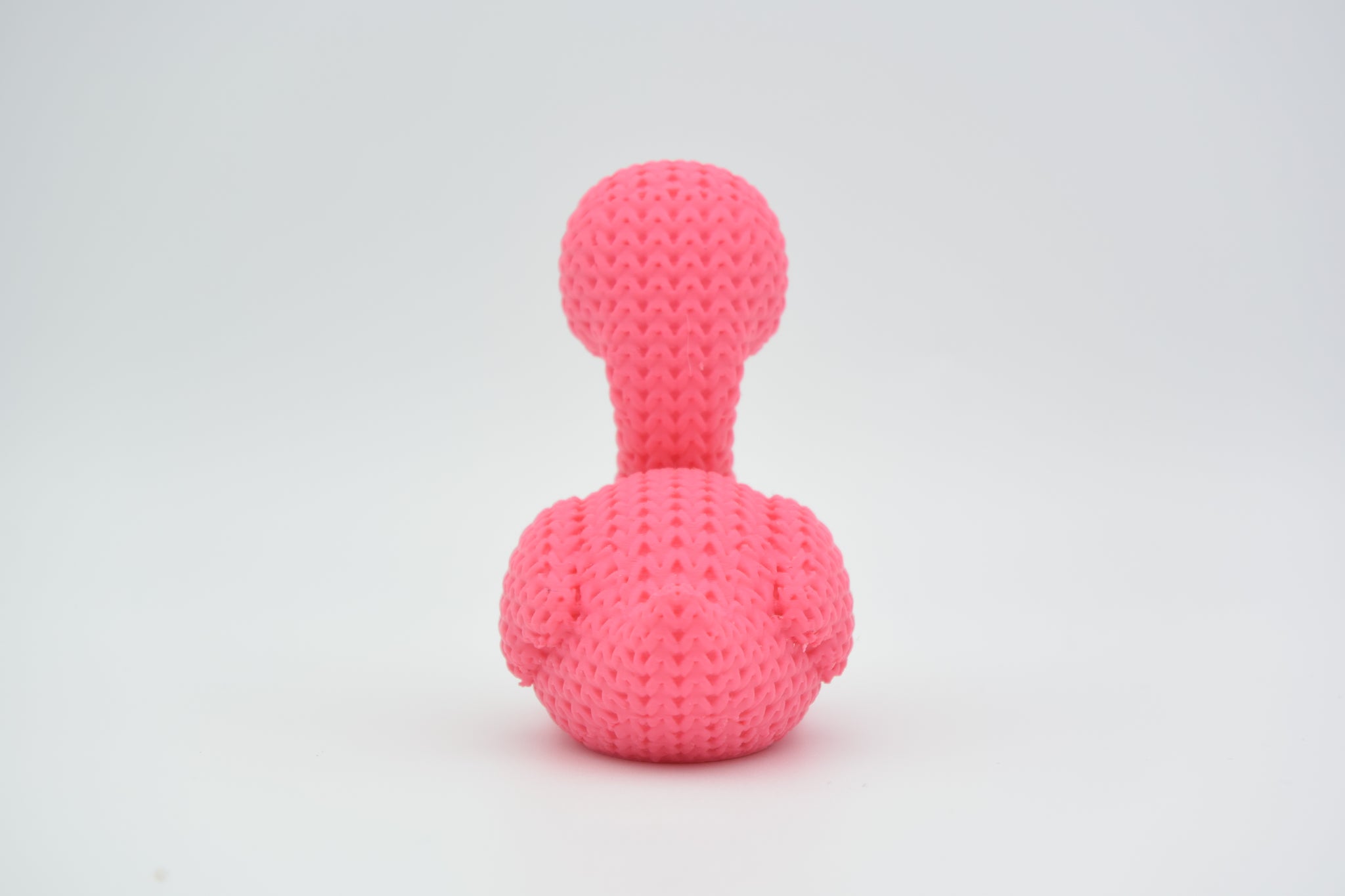 Detail shot of the looping crochet-look texture on the surface of a pink flamingo figurine