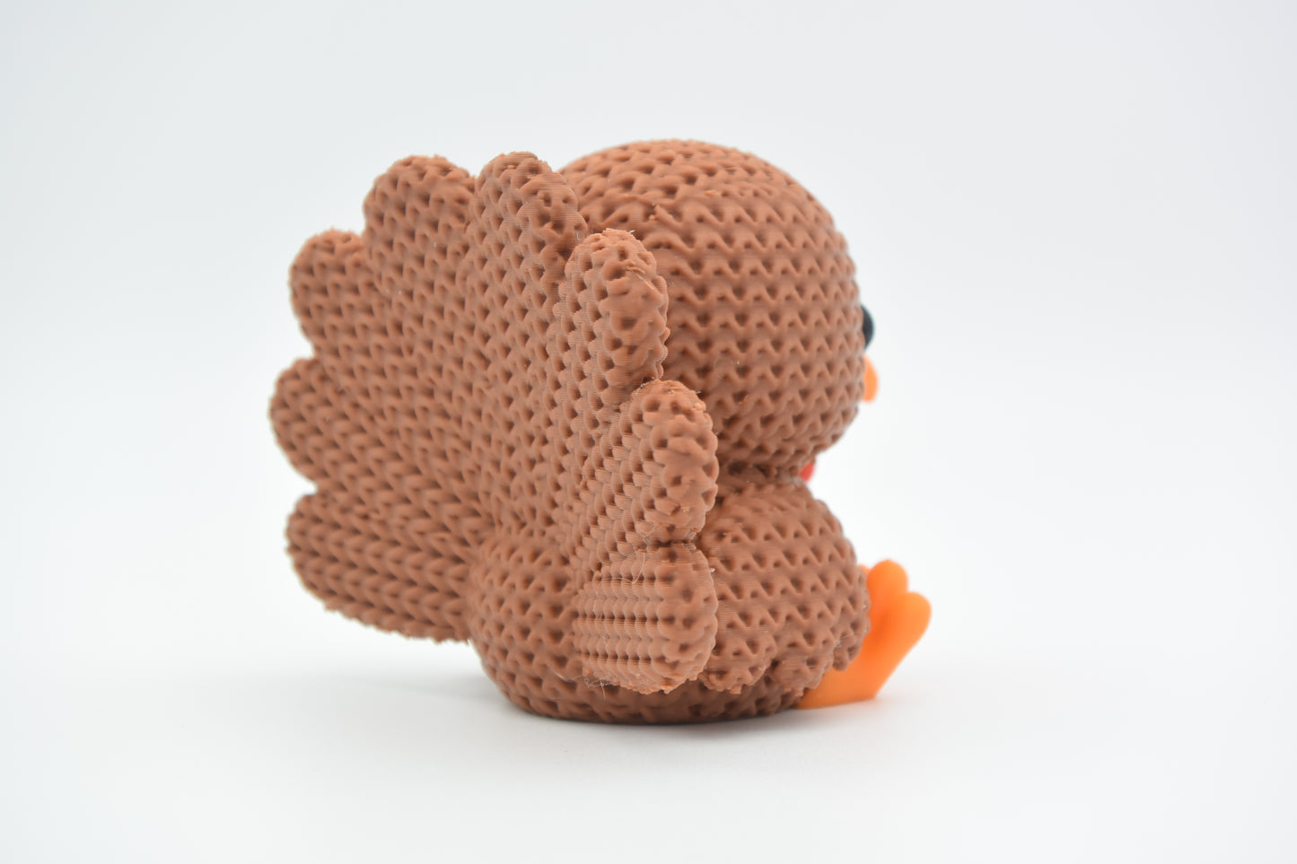 Detail shot of the crochet-look texture on the body of a knitted turkey decoration
