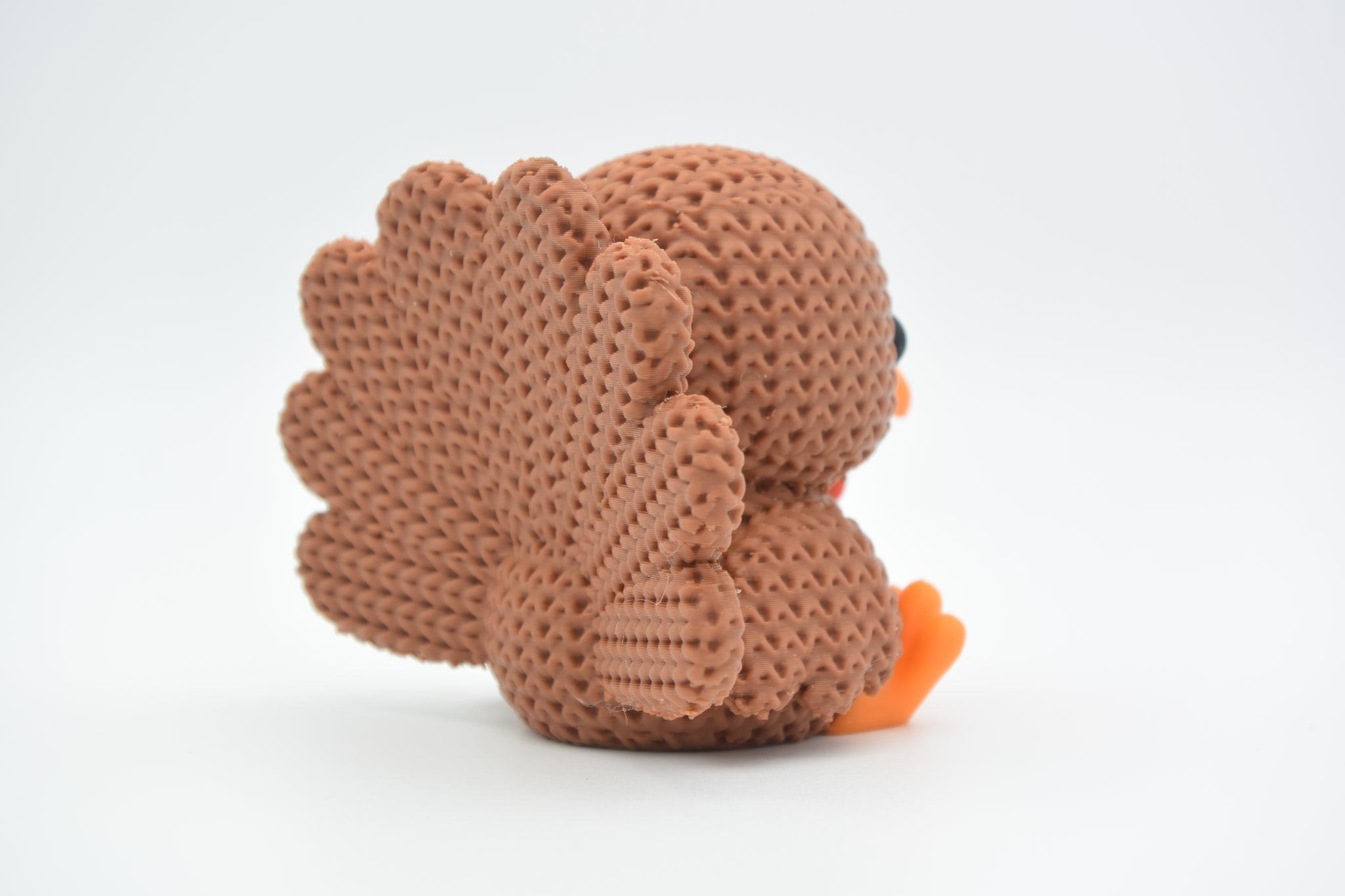 Detail shot of the crochet-look texture on the body of a knitted turkey decoration