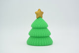 Small knitted Christmas tree styled on a wooden shelf beside candles in a Scandinavian holiday interior