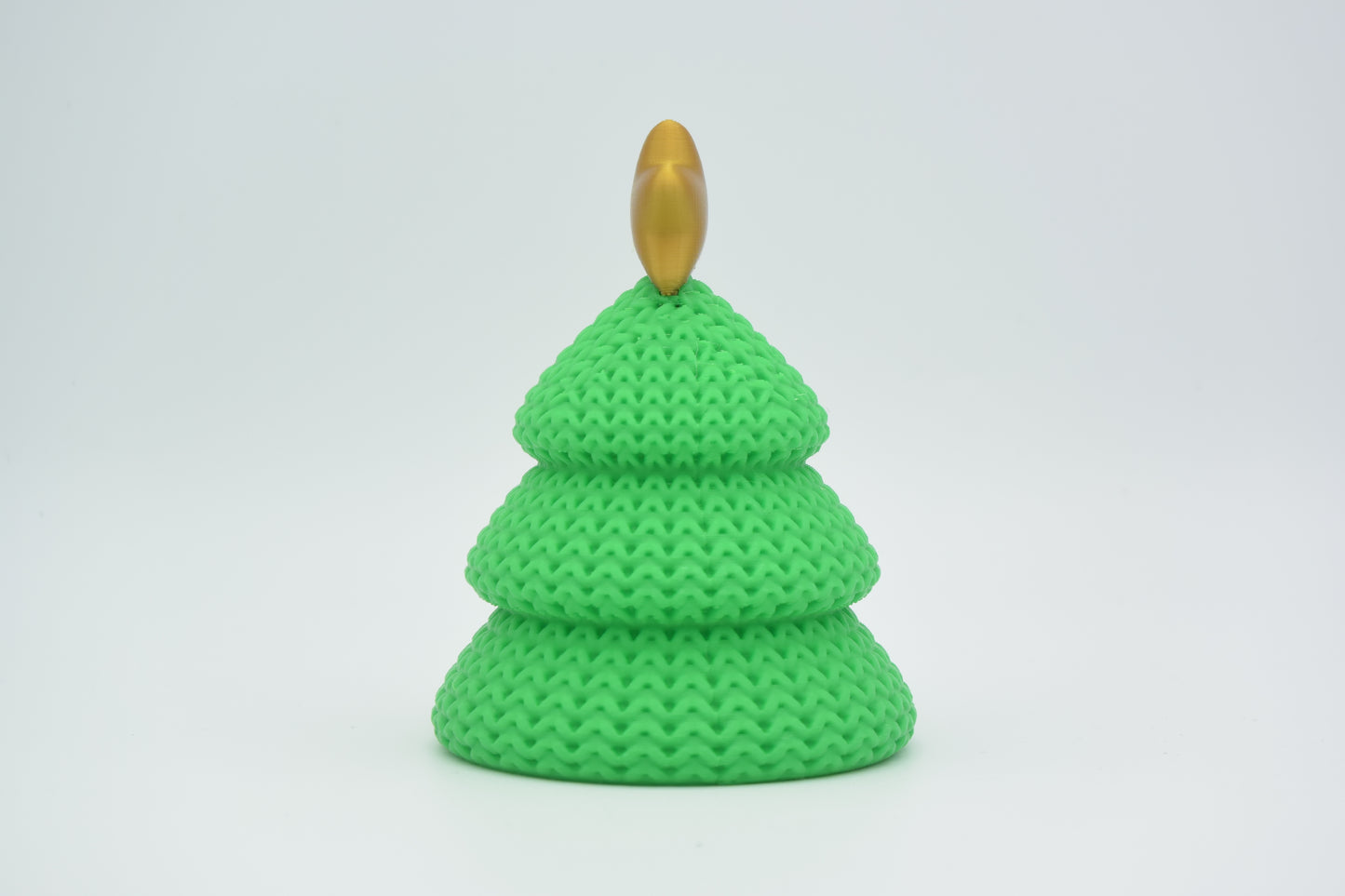 Texture detail of the knitted Christmas tree surface showing the soft woven pattern and layered tiers