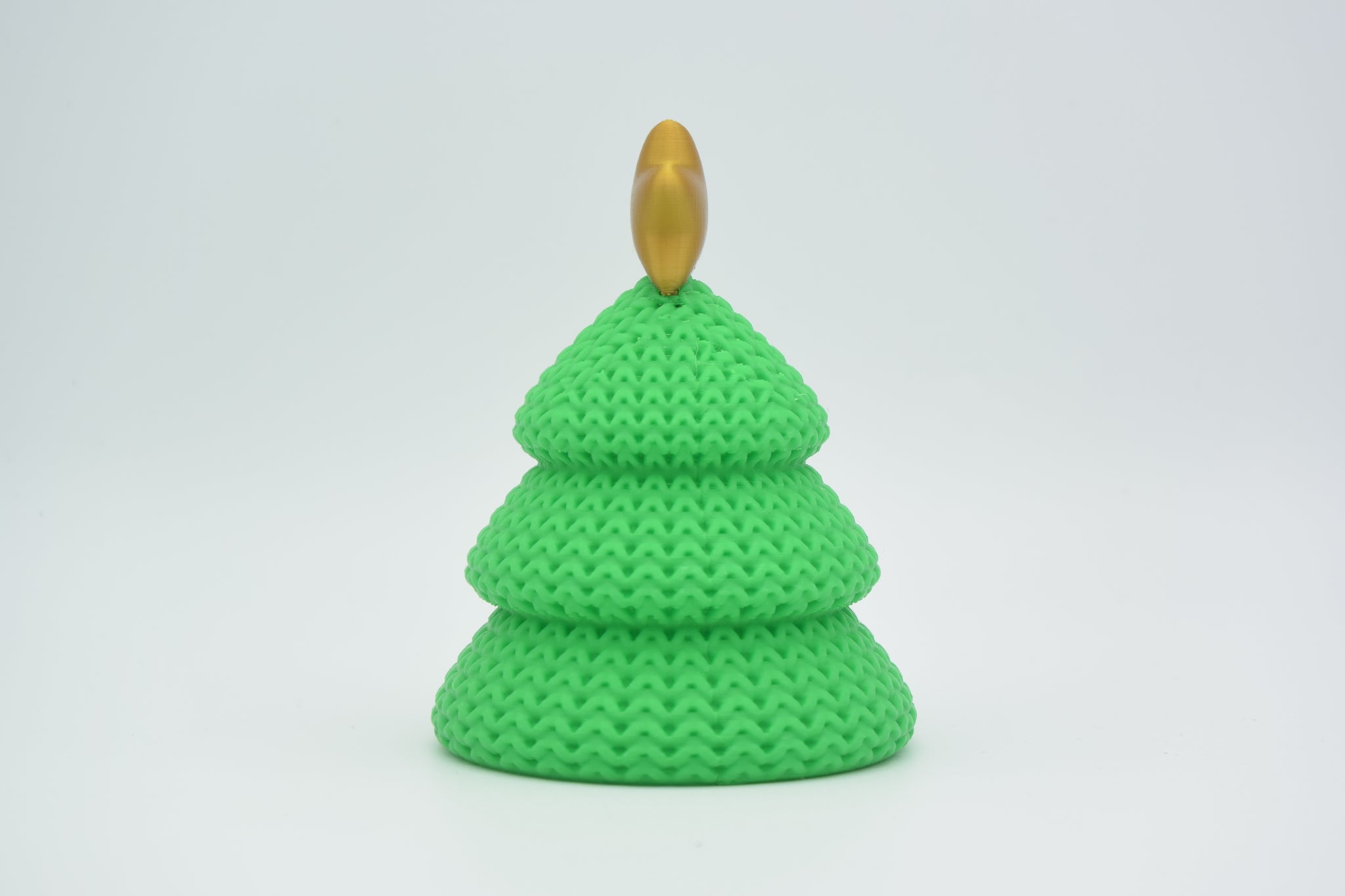 Texture detail of the knitted Christmas tree surface showing the soft woven pattern and layered tiers