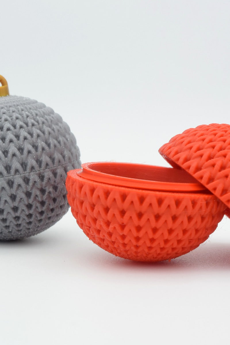 Knitted Christmas ornament with hidden compartment, shown in close-up against a neutral background